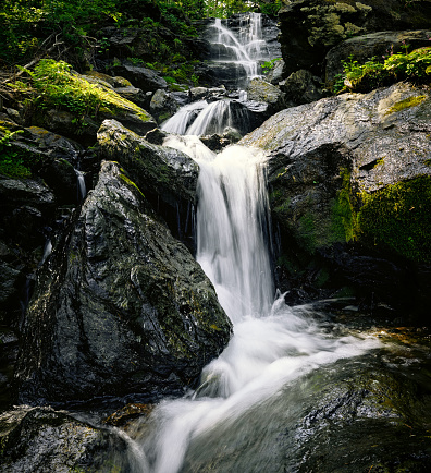 Beautiful waterfall in black stones mountain landscape