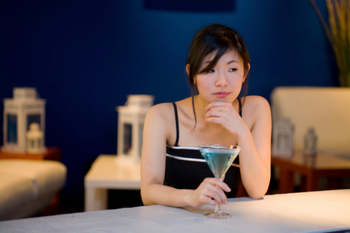 Woman looks a bit lonely at a bar