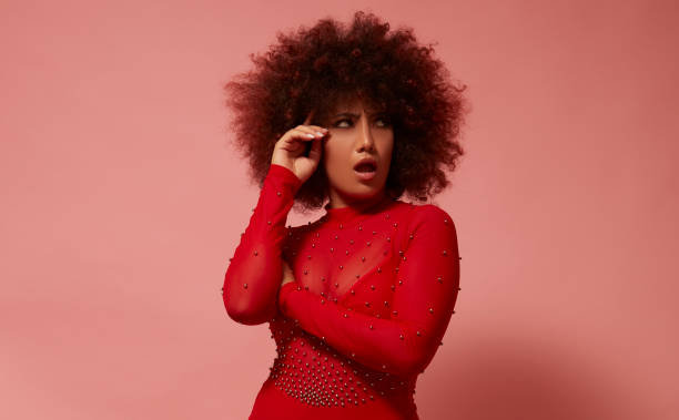 istock Curly-haired mixed race young woman in red. 1728455138