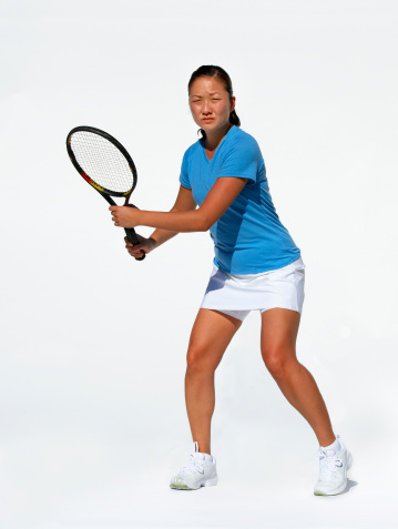 female tennis player setting up to return a Forehand. Isolated on White background.