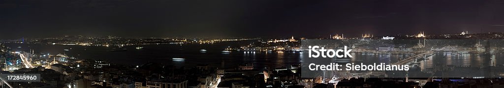 Panorama of Istanbul skyline at night from Galata Tower. "Panorama of Istanbul at night from Galata Tower.The Seraglio Point (Sarayburnu) where the TopkapA Palace is located is seen at the middle followed by (left to right) the Hagia Sophia, the Sultan Ahmed (Blue) Mosque, the Yeni (New) Mosque near the Galata Bridge, the BeyazAt Tower rising high in the background, and the SAleymaniye (Suleiman the Magnificent) Mosque at far right, among others.To the left is the first Bosphorus bridge." Asia Stock Photo