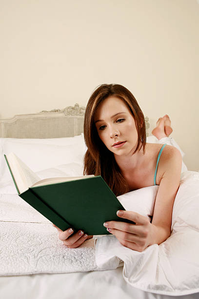 istock Girl reading in bed 172846124