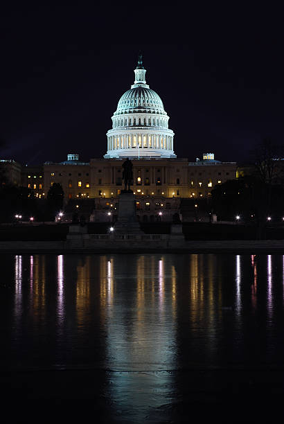 istock U.S. Capitol at night, with reflection on ice 172846275