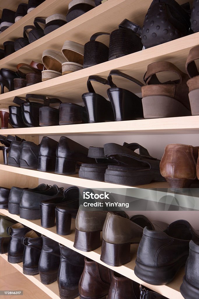 Closet Shoes Organization with Shelves and Racks in Storage Room Subject: A collection of shoes organized neatly along shelves in a shoes closet. Closet Stock Photo