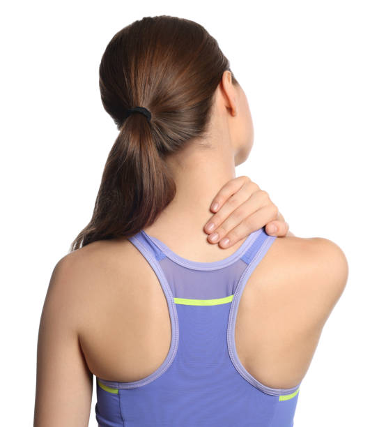 istock Young woman suffering from neck pain on white background, back view 1728464270