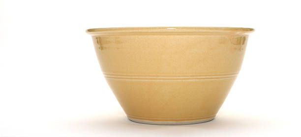 Tan ceramic bowl isolated on white background stock photo