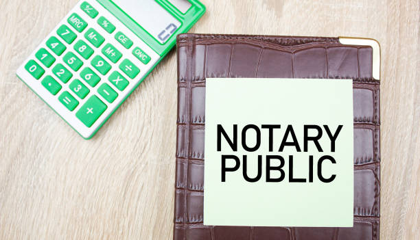 istock NOTARY PUBLIC text on sheet with notepad and calculator. Notary public concept. 1728476182