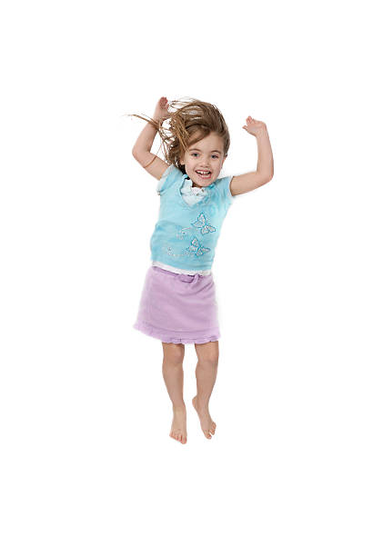 Little girl jumping stock photo