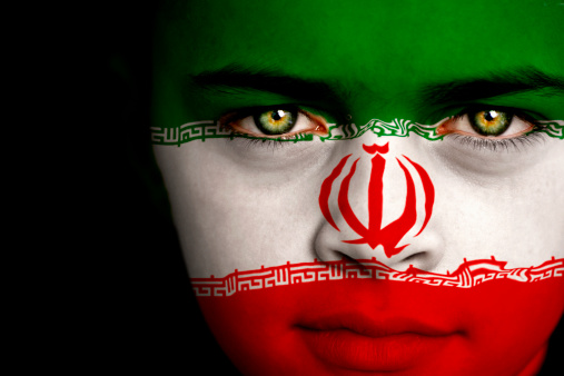 Portrait of a boy with flag of Iran on his face