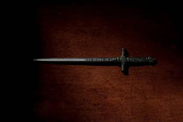 A sword with a red backdrop