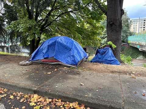A homeless camp tent on a city sidewalk