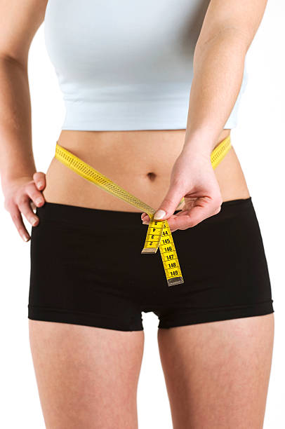 istock Woman measuring her waist 172854018