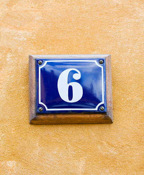istock House number 6, six. Blue enamel sign on yellow wall. 172854199