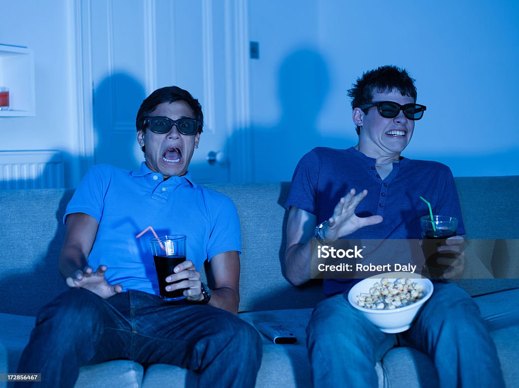 Teenage boys watching scary movie  Movie Stock Photo