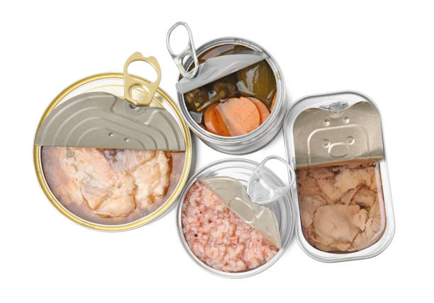 istock Open tin cans with different products on white background, top view 1728564879