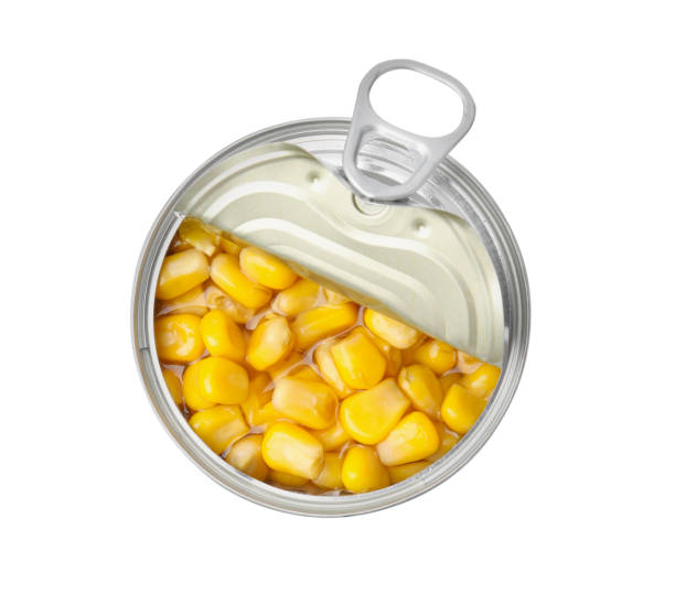 Open tin can of corn kernels isolated on white, top view