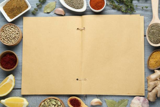 istock Blank recipe book surrounded by different ingredients on grey wooden table, flat lay. Space for text 1728565416