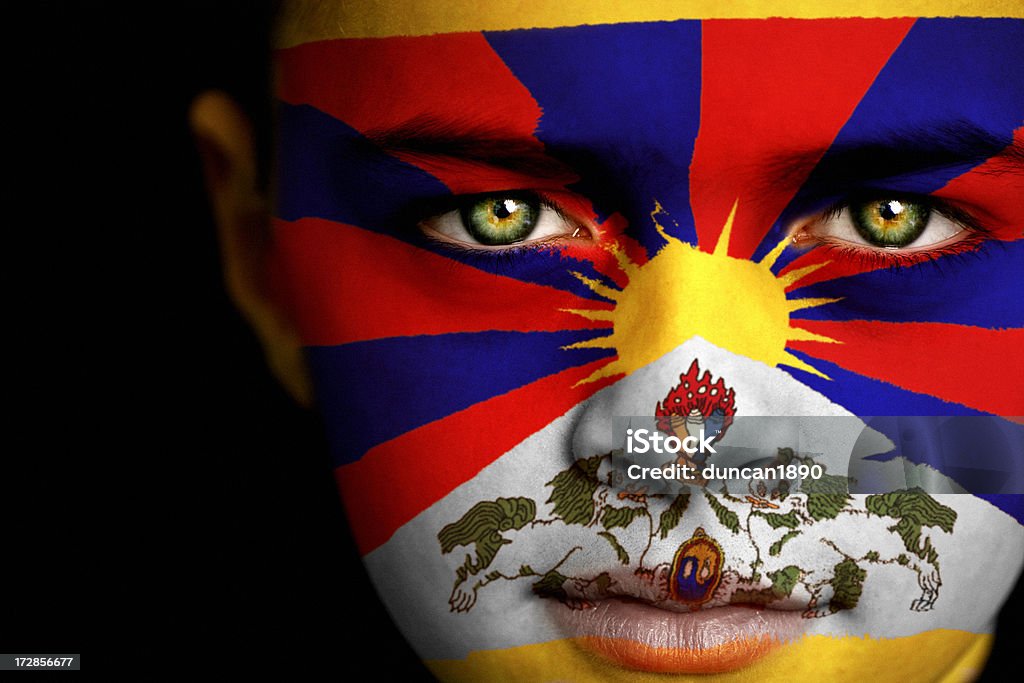 Tibet boy Portrait of a boy with flag of Tibet on his face Asia Stock Photo