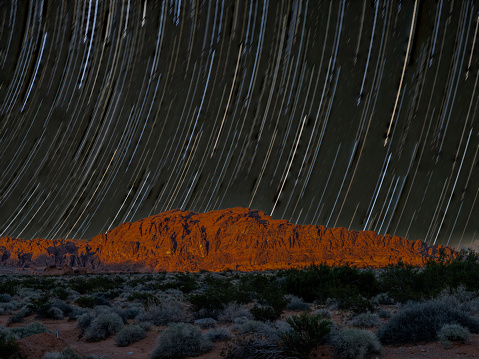 Star Trails over a red sandstone mountain in the Valley of Fire Landscape .Scenery in the Nevada desert.