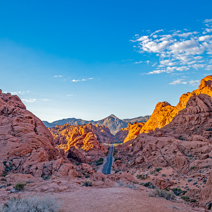 Iconic Road through Valley of Fire Landscape Scenery with a bright blue sky in the Nevada Desert.