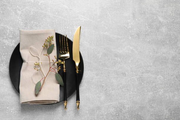 istock Stylish table setting with cutlery and eucalyptus leaves, top view. Space for text 1728571745