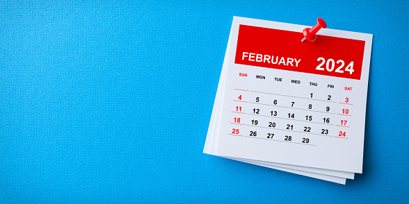 White Sticky Note With 2024 February Calendar And Red Push Pin On Blue Background