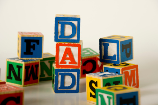 Childs building blocks stacked to spell DAD