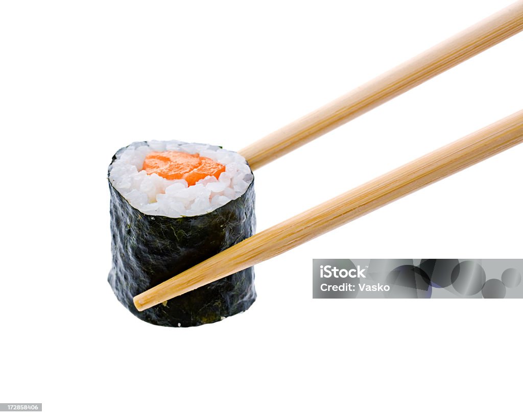 A sushi roll with salmon being held by wooden chopsticks Salmon roll on white background.   Sushi Stock Photo