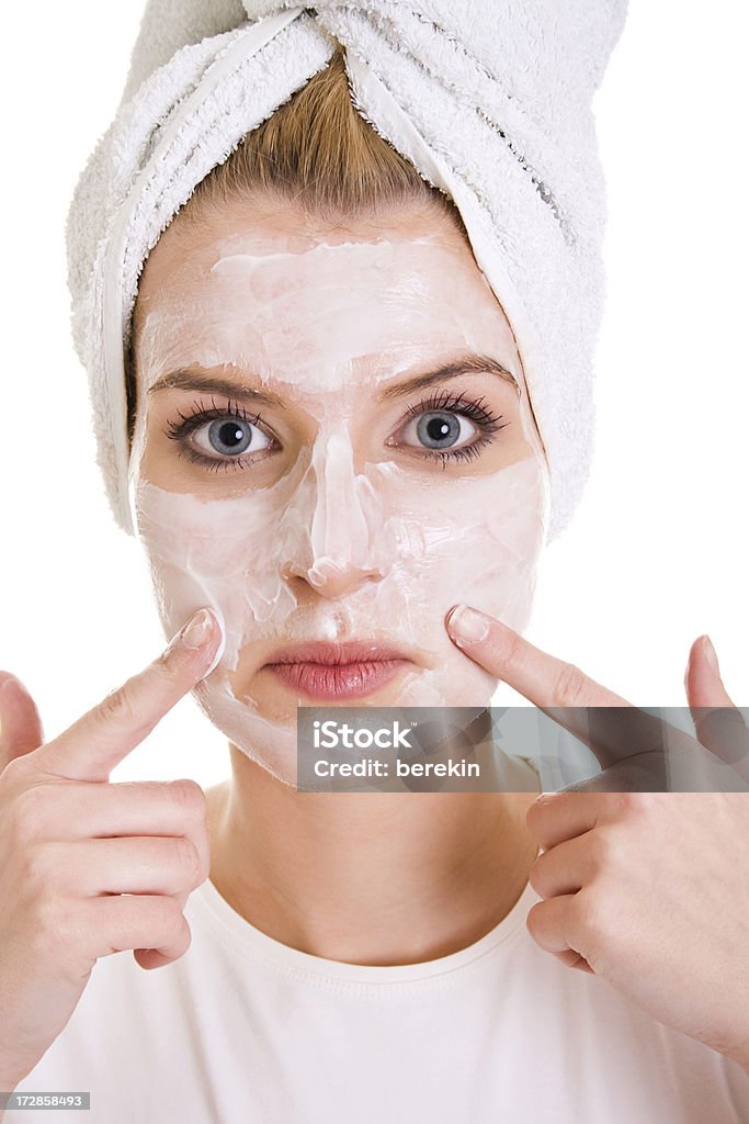 Woman with cream on face Woman with cream on face isolated on white Adult Stock Photo