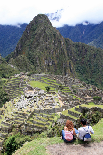 Young couple looking the famous Machu Picchu