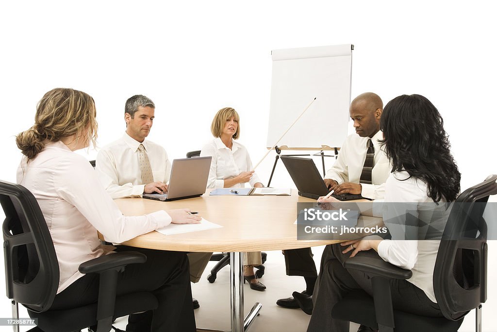 Business Team Meeting Photo of a business team in a meeting around a blank white easel paper pad.http://i114.photobucket.com/albums/n252/jbhorrocks/bizteam.jpg Conference Table Stock Photo