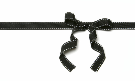 A black ribbon bow isolated on a perfect white background