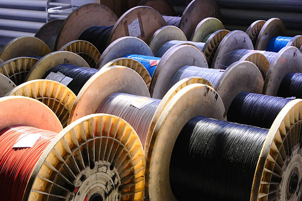 big spool of optic wire big spool of optic wire on a factory steel cable stock pictures, royalty-free photos & images