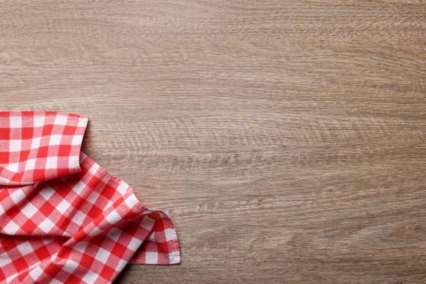 istock Checkered tablecloth on wooden table, top view. Space for text 1728595141