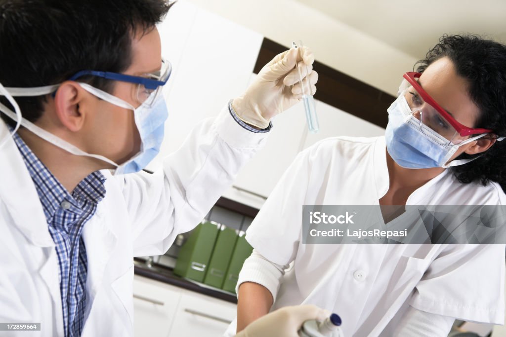 Working in the laboratory Young people working in the laboratory. Trying to find the active substance of a vaccination against the flu. 20-29 Years Stock Photo