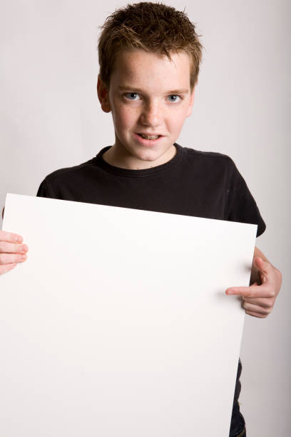 istock Boy is holding a blank advertising poster 172860438