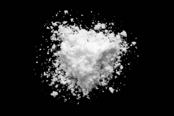 istock White snow isolated on black background close up 1728605192