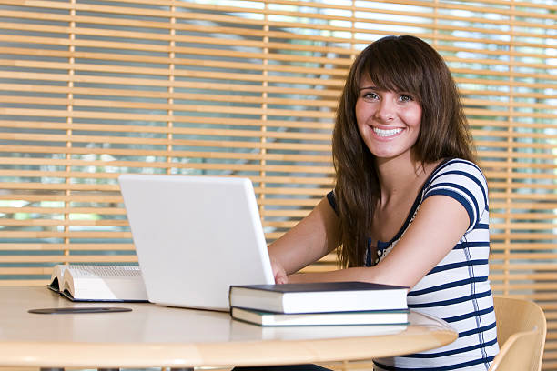 istock Young woman studying in library 172860548