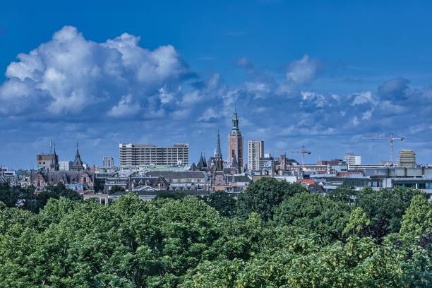 den haag, netherlands - may 30 2022: skyline of the city with historic buildings as also with modern offices with the malieveld and a blue cloudy sky