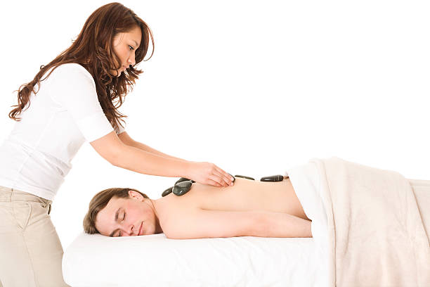 massagem com pedras quentes - massage therapist stone spa treatment working - fotografias e filmes do acervo