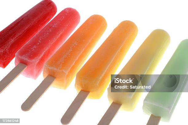 Line Of Colorful Flavored Ice Isolated On White Stock Photo - Download Image Now - Flavored Ice, Rainbow, Stick - Plant Part