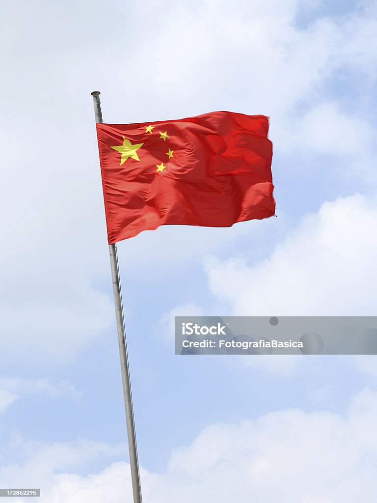 Chinese flag Waving chinese flag against cloudy sky. Flag is motion blurred Chinese Flag Stock Photo