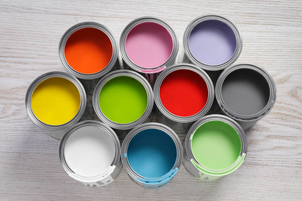 istock Cans of different paints on white wooden table, flat lay 1728629547