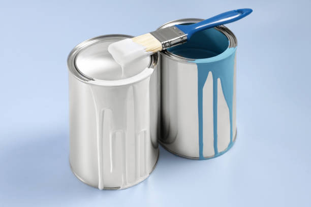 istock Cans of paints and brush on light blue background 1728630086