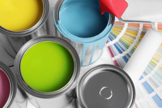Cans of paints, roller and palette on white background, above view