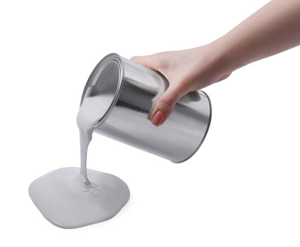 istock Woman pouring paint from can on white background, closeup 1728630641