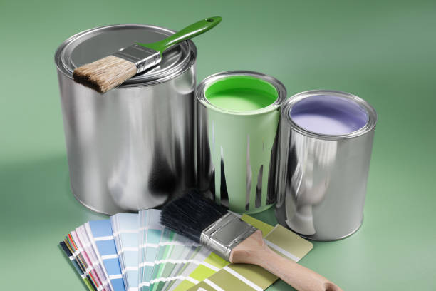 istock Cans of paints, palette and brushes on light green background 1728630666