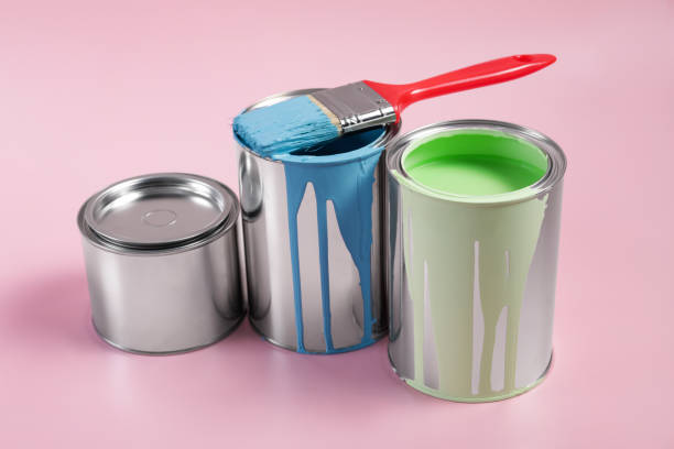 istock Cans of paints and brush on pink background 1728630685