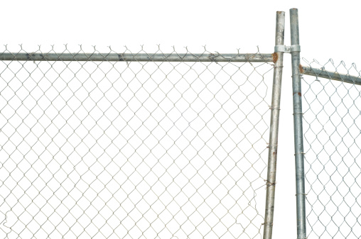 A chainlink fence is isolated on pure white waiting for you to add a background.