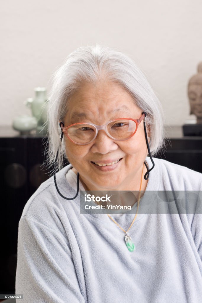 Asian Senior Relaxed at Home Subject: Portrait of an Asian woman relax at her home. 80-89 Years Stock Photo